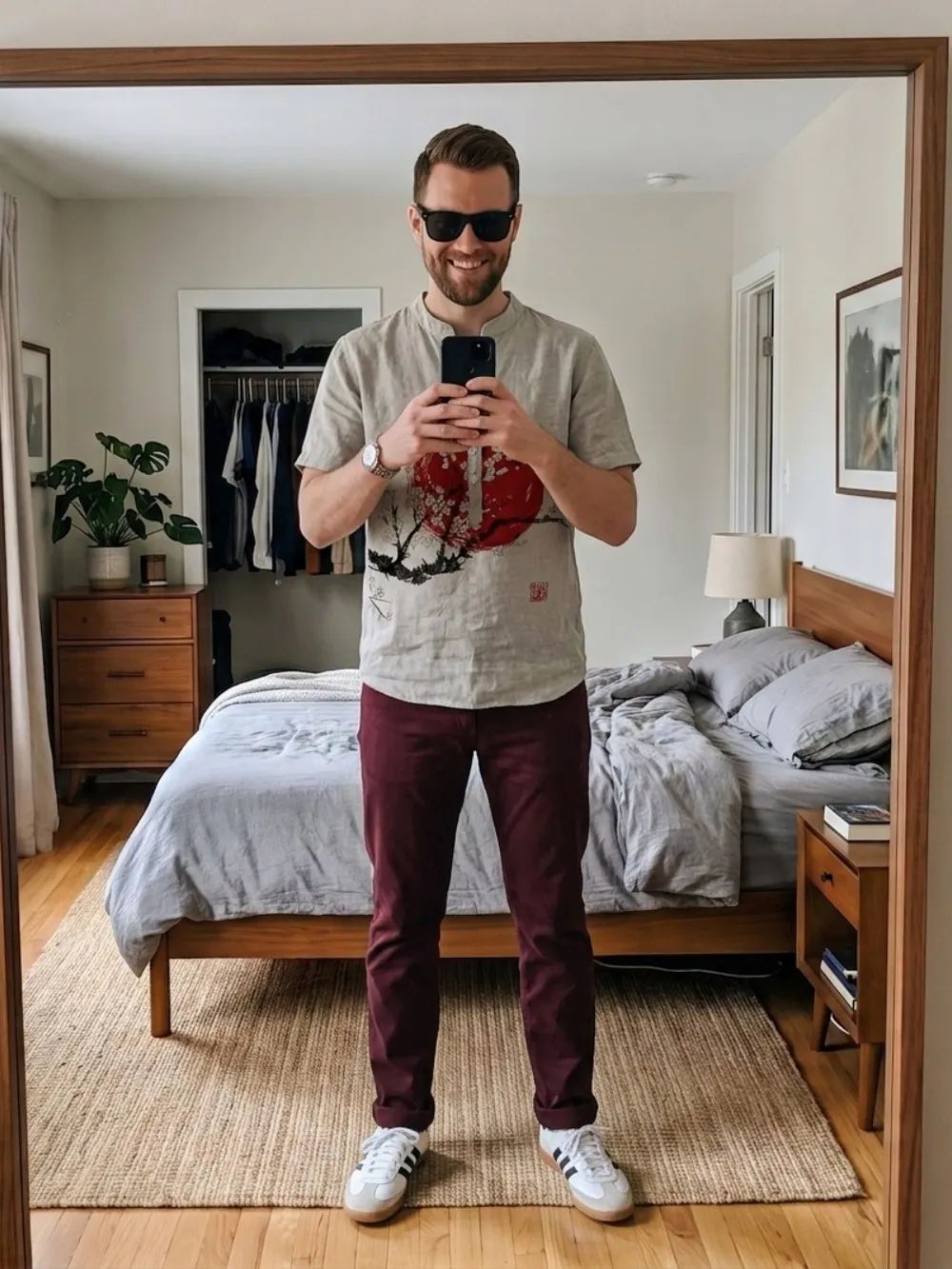 A blossom-print linen shirt and burgundy trousers rendered onto a saved photo. AI-generated image.